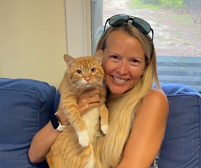 Newly adopted orange cat with owner